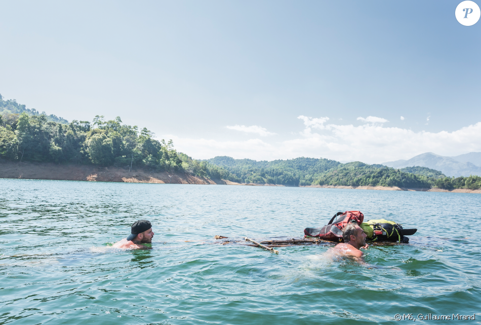 Two men swim in clear water