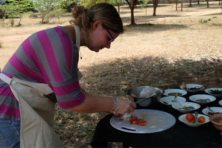 A lady getting cooking experience at campsites 