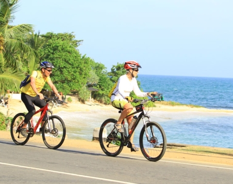 two mans cycling in coastal areas in Sri Lanka 